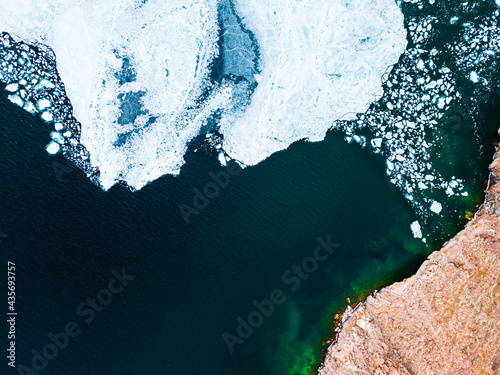Melting ice floes on the shore of Baikal lake in spring. Aerial drone view. Baikal lake, Siberia, Russia © smallredgirl