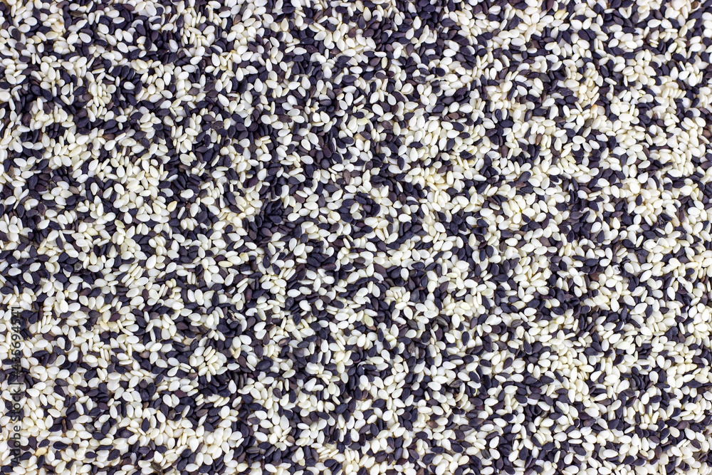 Top view of black and white mix sesame seeds texture as a food background.
