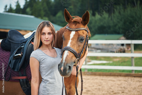 portrait of beautiful girl with horse at the ranch