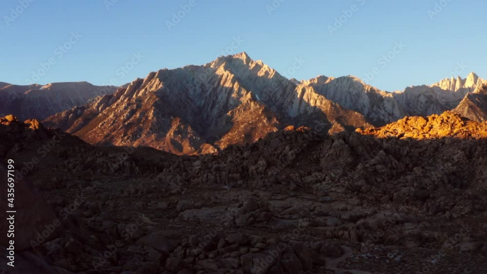 Panning Away From Rugged Mountain Peaks, With Dramatic Sunlight, Clear Blue Sky, And Rocky Terrain - Sierra, California Panning Away From Rugged Mountain Peaks, With Dramatic Sunlight, Clear Blue Sky, And Rocky Terrain - Sierra, California