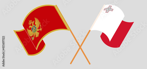 Crossed and waving flags of Montenegro and Malta