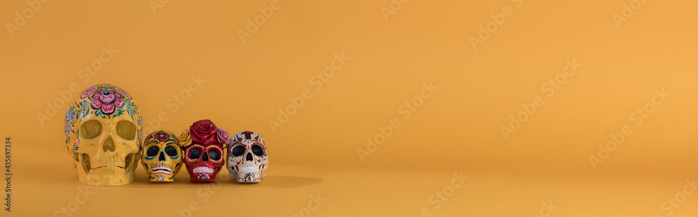 Day of the Dead, colorful skulls on yellow background Day of the Dead, colorful skulls on yellow background