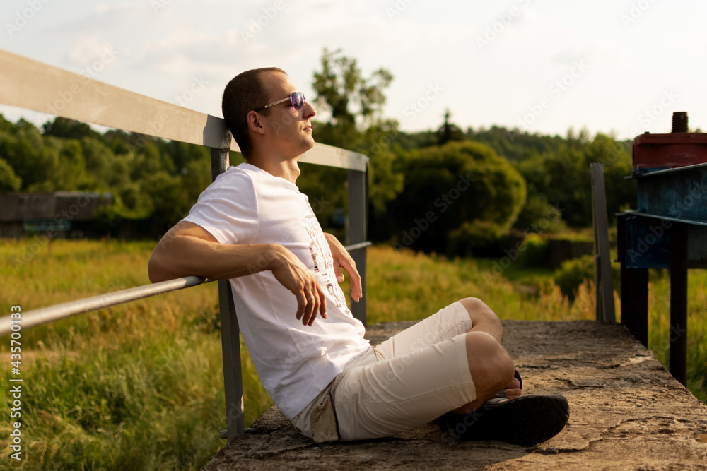 The man is sitting in a relaxing position. The man is sitting in a relaxing position.