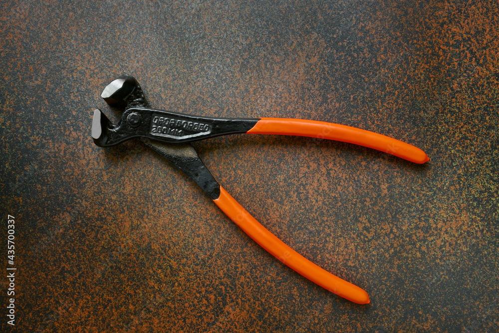 Obraz premium Locksmith pliers, drop forged metal, professional realistic tool on a dark background close up