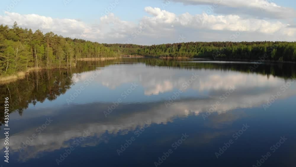 Lake, forest and yellow field in spring sunrise light 4k aerial top view. Fly above water of lake Dolgoe, Belarus. Drone aerial video Lake, forest and yellow field in spring sunrise light 4k aerial top view. Fly above water of lake Dolgoe, Belarus. Drone aerial video