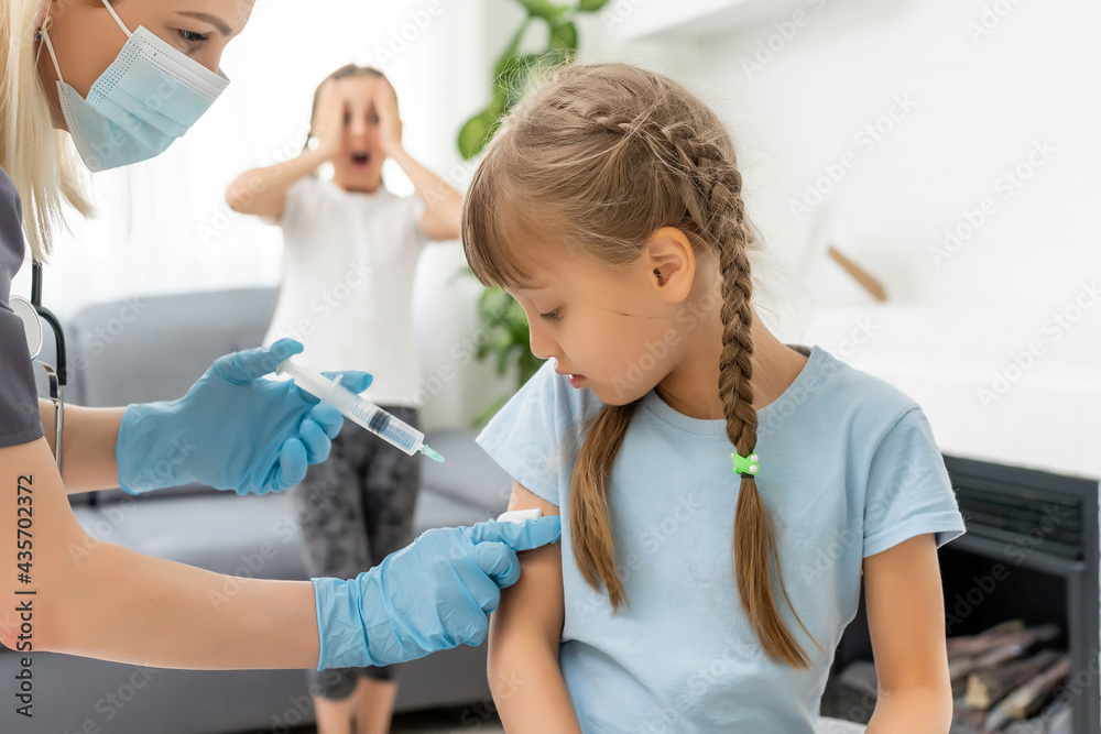 The doctor makes a child vaccination The doctor makes a child vaccination