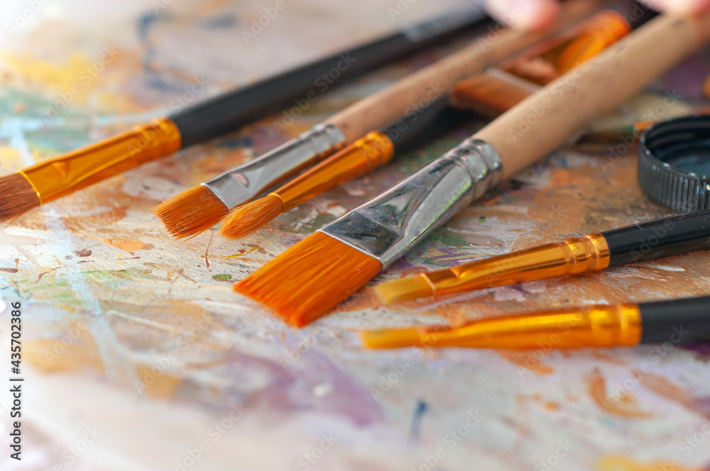 Obraz premium Brushes on the artist's canvas are covered with paints