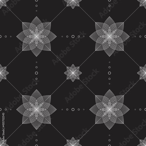 Black and white seamless pattern tile with flowers and geometric shapes.