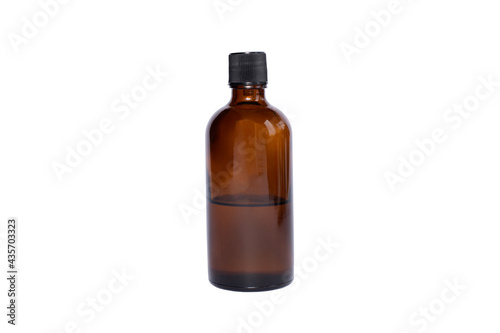 medical brown glass oil jar with black lid on white isolated background