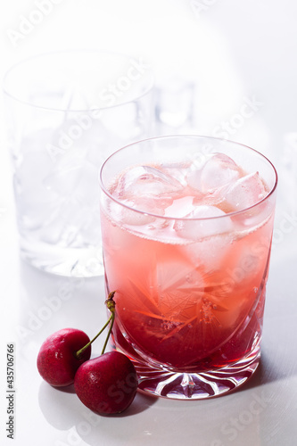 Beautiful red cherry cocktail in the summer sunshine