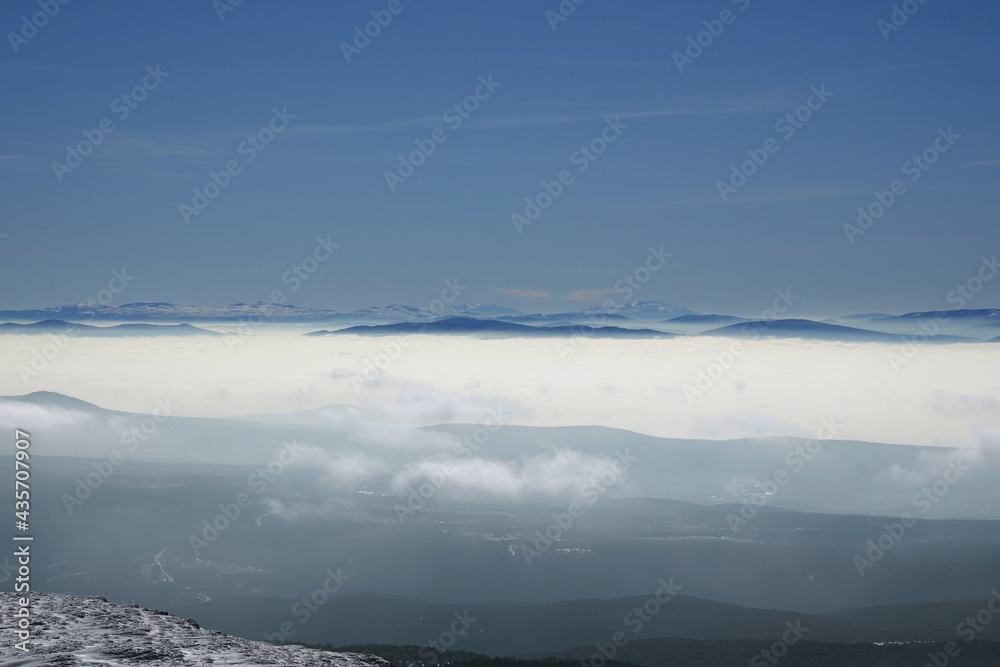 view of snowy mountains in fog