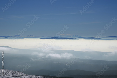 view of snowy mountains in fog