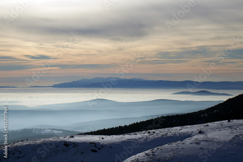 view of foggy mountains at sunrise © scetin