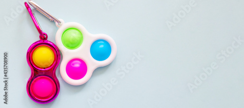 colorful antistress sensory toy fidget push simple dimple on blue background