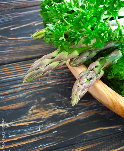 asparagus  parsley on a wooden background