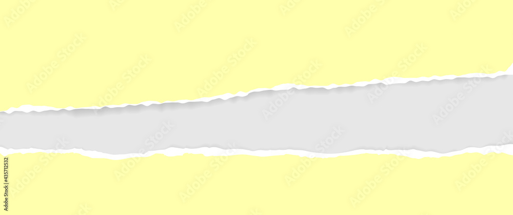A torn, ripped strip of yellow paper with a light shadow on a gray background for text. A torn piece of cardboard.