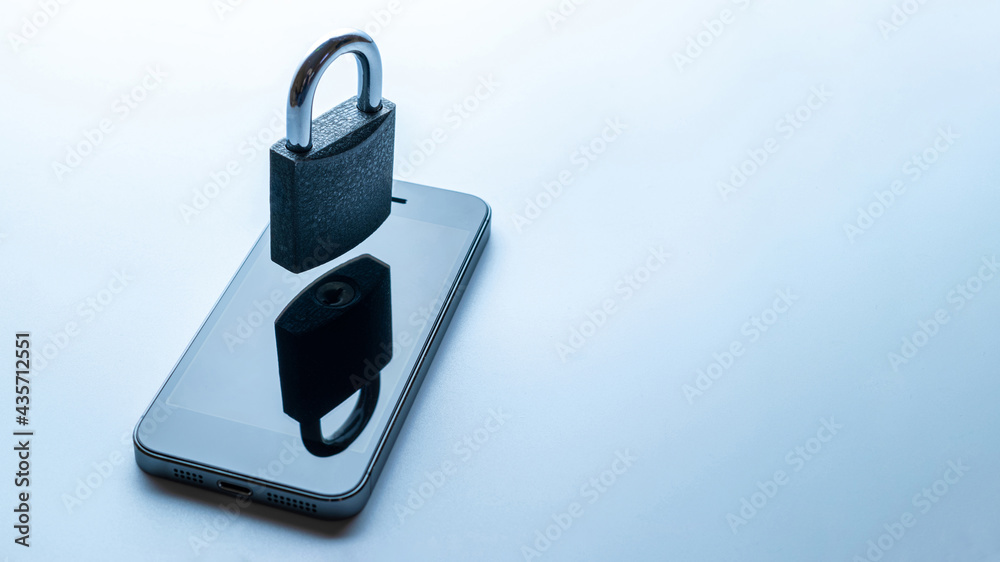 Business security protection. Modern space grey mobile phone with padlock, key on white background. Smartphone fraud, online scam and cyber security threat.