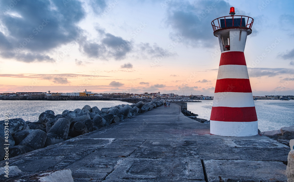 Sunset at the lighthouse of the pier of Peniche, Portugal