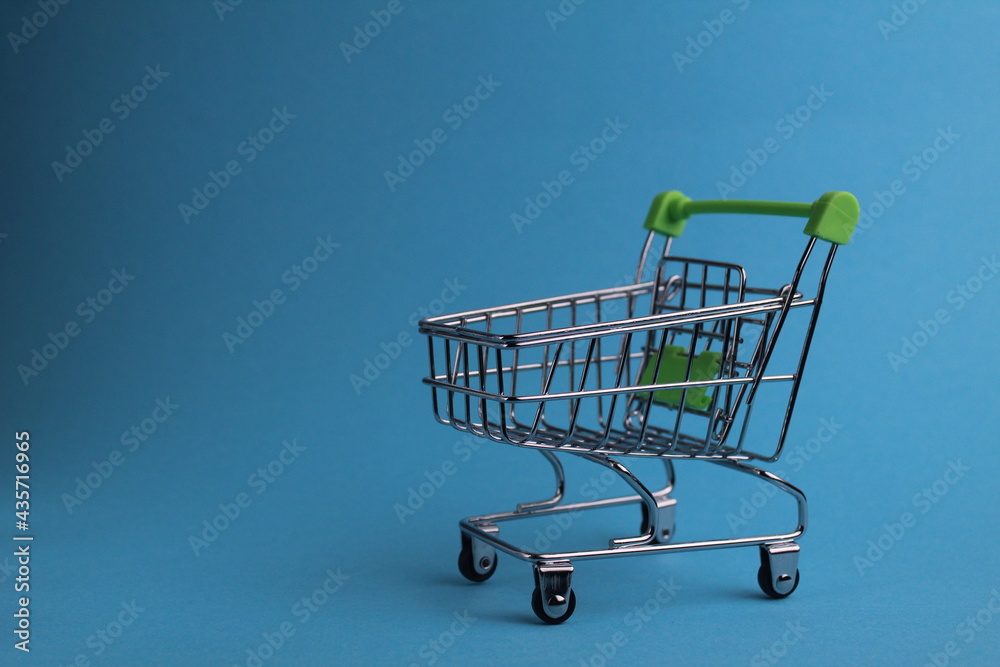 shopping cart on a blue background with a copyspace. purchases. business. Buyer demand. shop. Buyers shopping cart on a blue background with a copyspace. purchases. business. Buyer demand. shop. Buyers