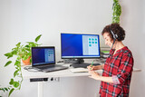 Woman telecommuting at an adjustable standing desk