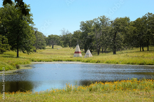 Wallpaper Mural Teepees behind a lake in Oklahoma