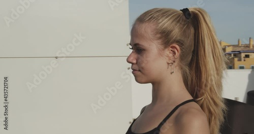 Panning Shot Of A Young Lady With Pierced Ears photo