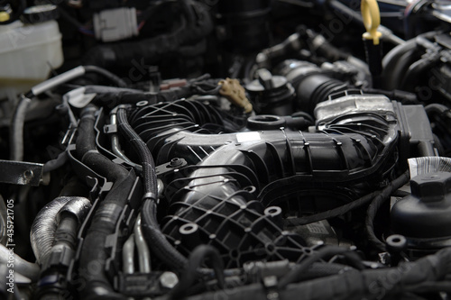 Close-up of a modern powerful engine. Top section, intake manifold, selected focus.