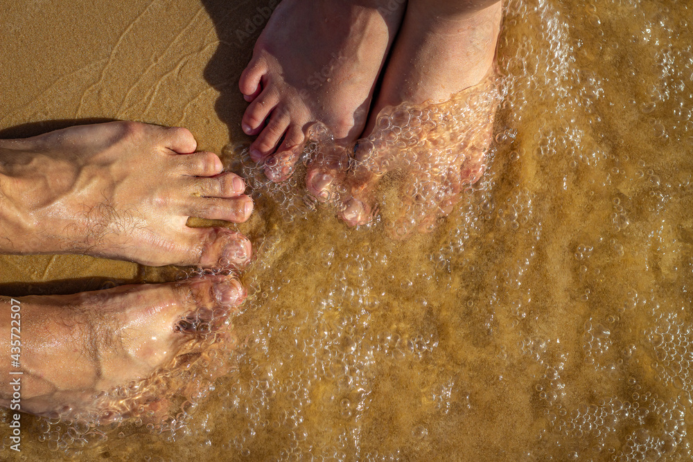Fototapeta premium feet on the wet sand