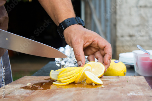knife cutting lemon on table