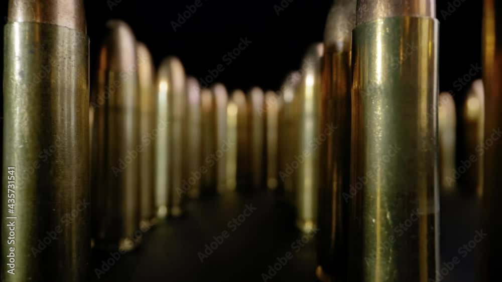 DOLLY OUT OF A CACHE OF RIFLE BULLETS.  4K, WIDE ANGEL, MACRO SHOT.  NO PEOPLE.