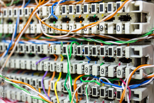 Closeup Inside a PBX telephone booth that has a number of connecting cables in many colors in the analog system.