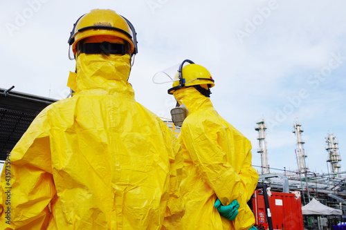 Photography Rescue personnel wear yellow chemical protective clothing during chemical spill recover as part of emergency drills at chemical plant