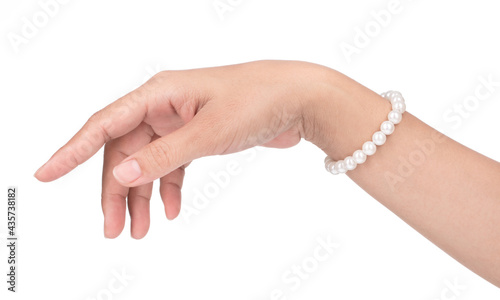 Fotografie Pearl bracelet on a hand isolated on a white background.
