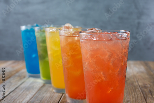 A view of several iced cold drinks with a rainbow motif.