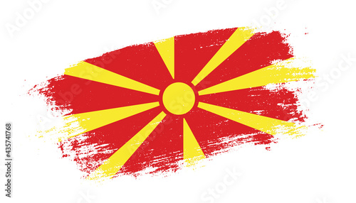 Flag of North Macedonia country on brush paint stroke trail view. Elegant texture of national country flag photo