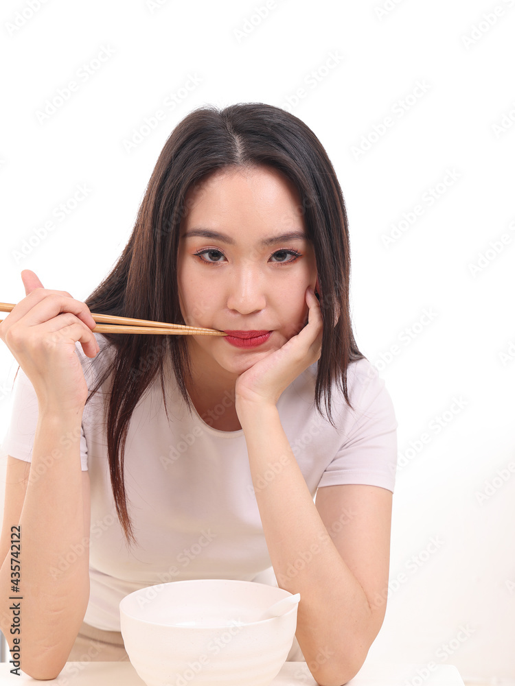 Beautiful young south east Asian woman holding chinese empty chopstick soup spoon bowl utensil pretend acting posing see eat taste feed offer satisfaction yummy white background happy Beautiful young south east Asian woman holding chinese empty chopstick soup spoon bowl utensil pretend acting posing see eat taste feed offer satisfaction yummy white background happy