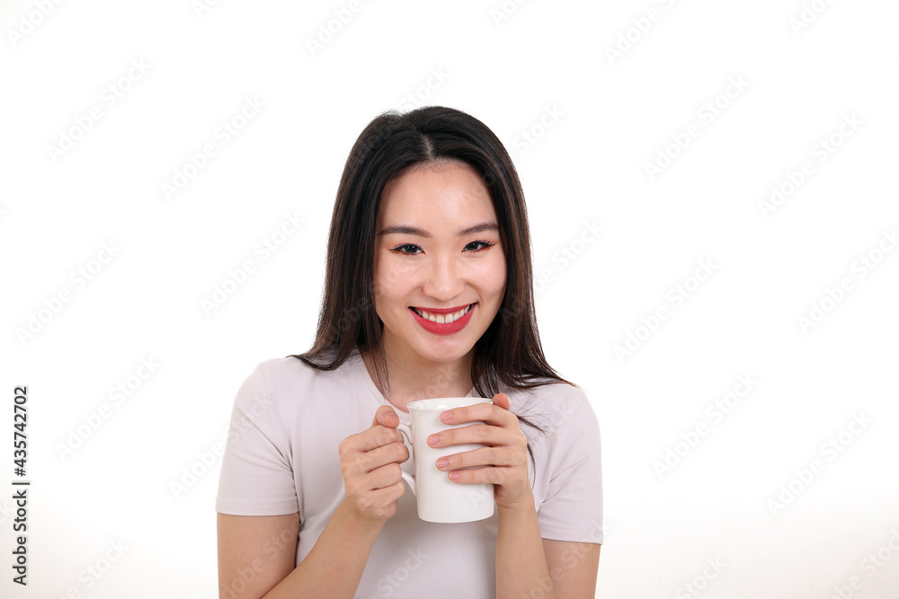 Beautiful young south east Asian woman holding white coffee tea cup emotion expression on white background look at camera smile Beautiful young south east Asian woman holding white coffee tea cup emotion expression on white background look at camera smile