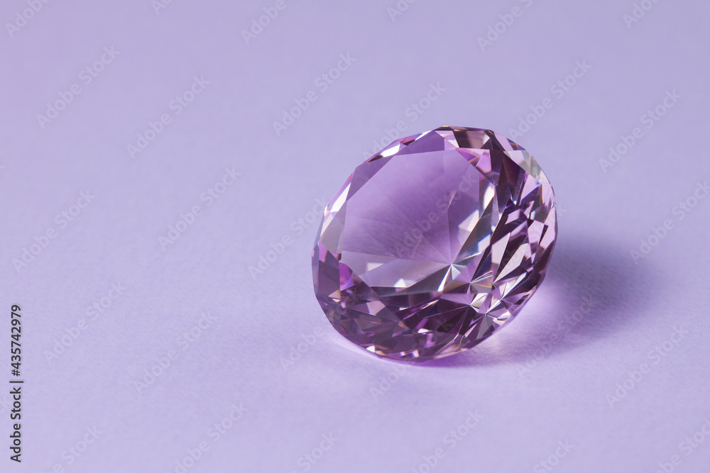 Purple precious gemstone for design gems jewellery. Diamond crystal on turquoise background. Purple precious gemstone for design gems jewellery. Diamond crystal on turquoise background.