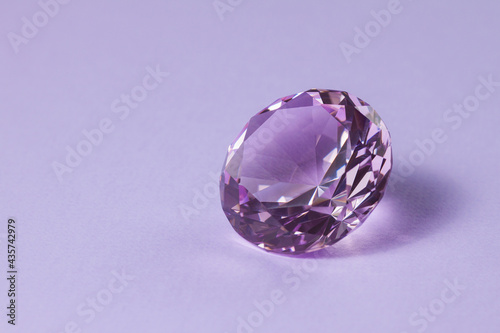 Purple precious gemstone for design gems jewellery. Diamond crystal on turquoise background.