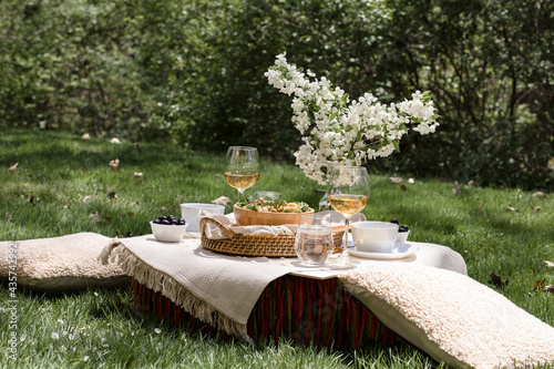 Al fresco dinning in backyard with pasta and drinks in lush green surrounding