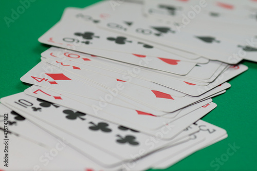 Classic playing cards on green background. Gambling and casino concept.