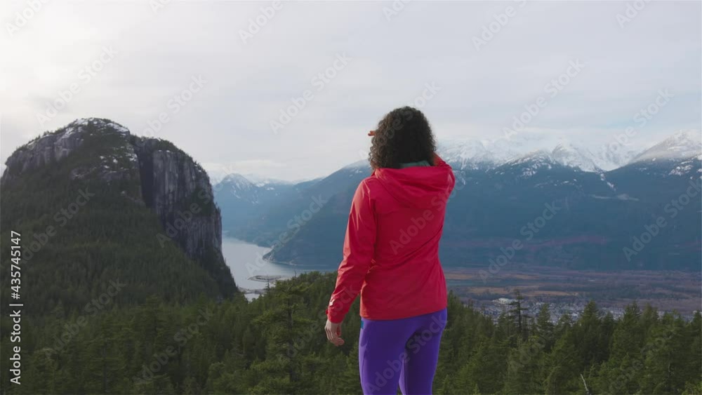Adventurous Girl Hiking in the mountains during a sunny Winter Sunset. Taken in Squamish, North of Vancouver, British Columbia, Canada. Concept: Adventure, freedom, lifestyle, health, sport Adventurous Girl Hiking in the mountains during a sunny Winter Sunset. Taken in Squamish, North of Vancouver, British Columbia, Canada. Concept: Adventure, freedom, lifestyle, health, sport