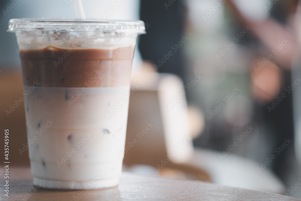 Cold iced latte coffee, the bottom as milk top by coffee shot in a plastic glass 16oz. Cold iced latte coffee, the bottom as milk top by coffee shot in a plastic glass 16oz.