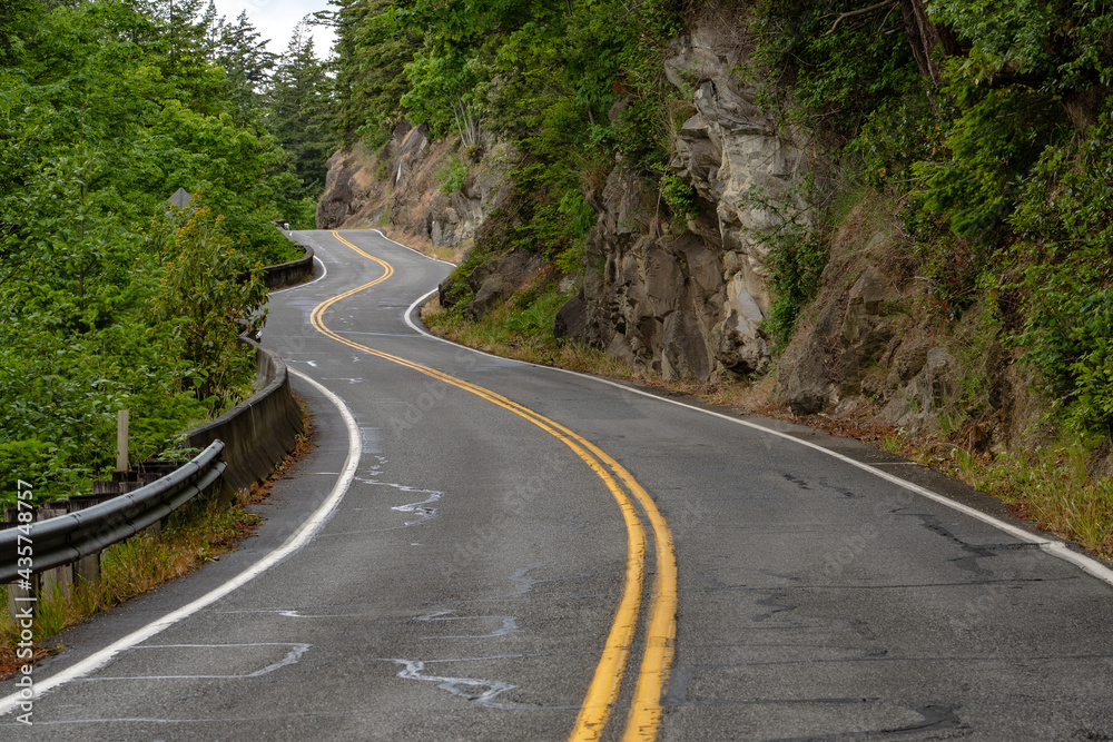 Winding paved roadway curves along mountainside