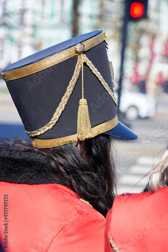 Fotografie Old hussar hat on the head of a girl with black hair