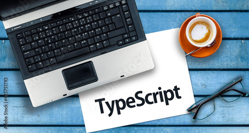 TypeScript Programming Language. Word TypeScript on paper and laptop
 photo