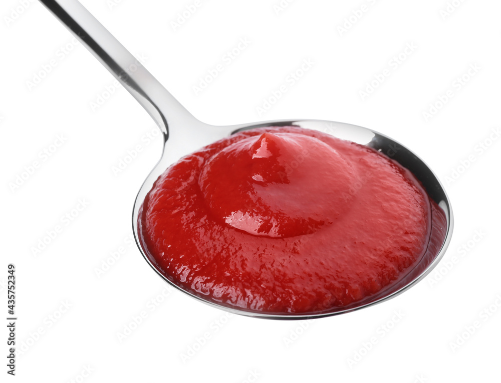 Spoon with tasty ketchup on white background