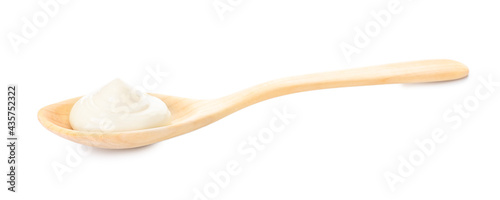 Spoon with tasty mayonnaise on white background