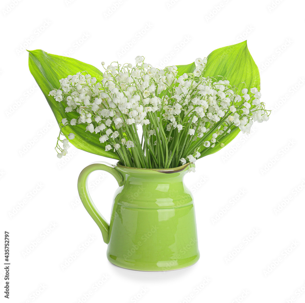 Jug with beautiful lily-of-the-valley flowers on white background