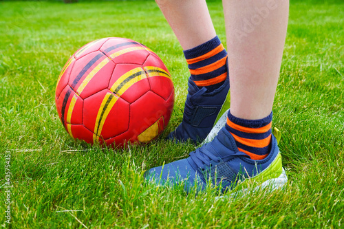  Kids sport outdoor. Child plays yard football. amateur soccer sport outside on the playing field. Close up ball lying on the grass.